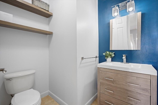 bathroom featuring tile patterned flooring, vanity, and toilet