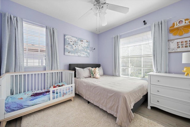 bedroom featuring hardwood / wood-style flooring and ceiling fan