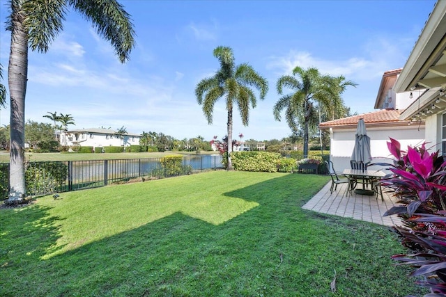 view of yard featuring a water view and a patio