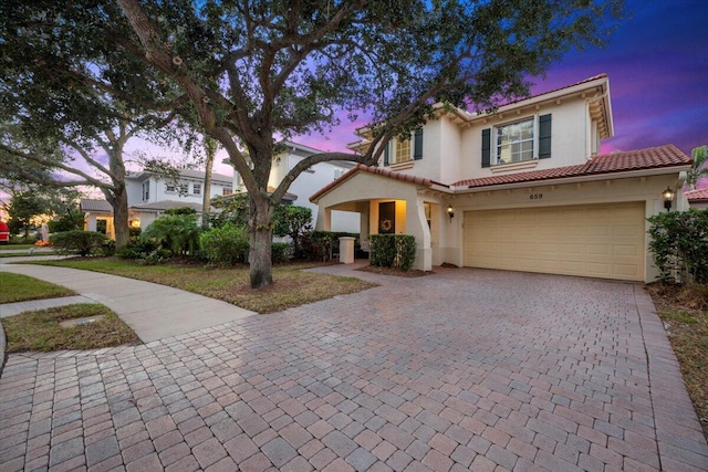 mediterranean / spanish house featuring a garage