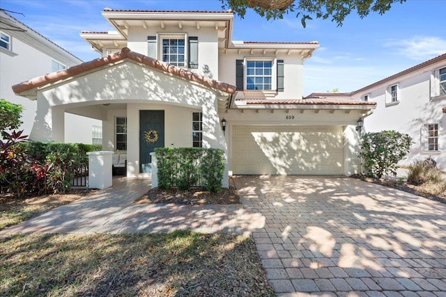 mediterranean / spanish home featuring a garage