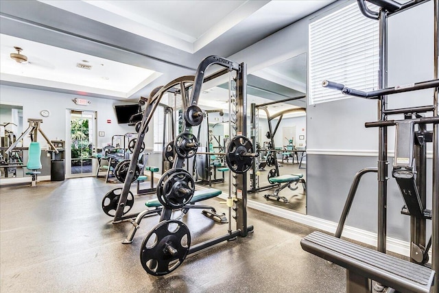 workout area featuring a raised ceiling