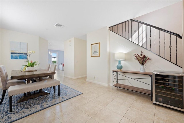 dining room with light tile patterned floors and beverage cooler