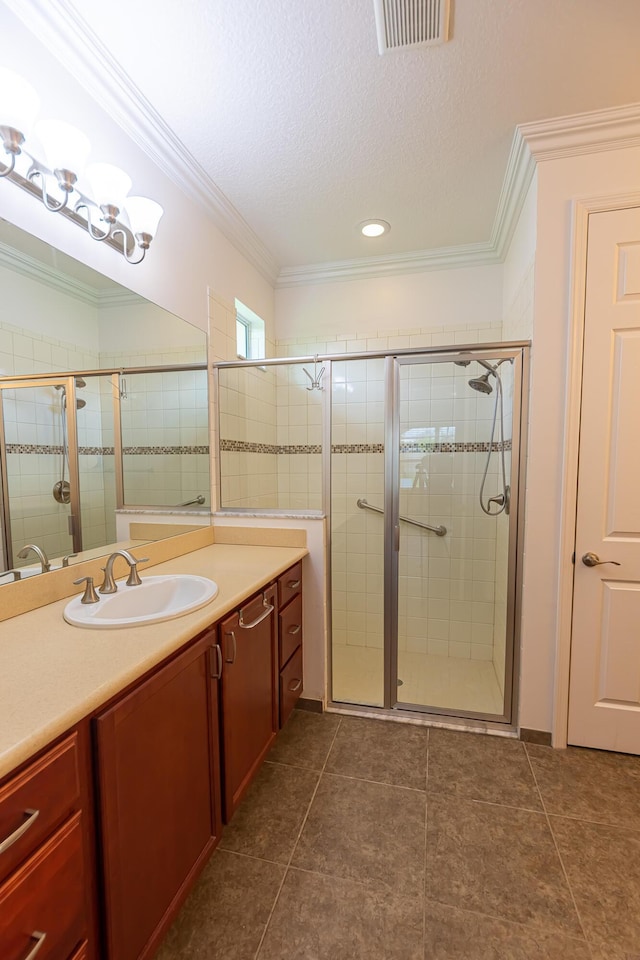 bathroom featuring vanity, ornamental molding, a textured ceiling, and walk in shower