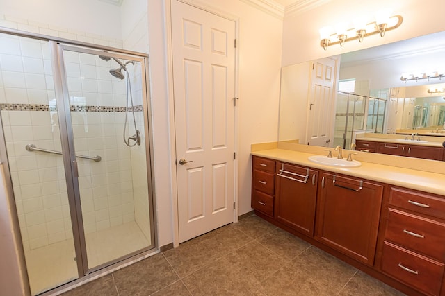 bathroom featuring ornamental molding, a shower with door, and vanity