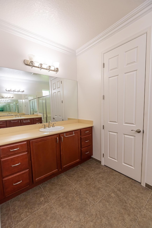 bathroom featuring vanity, ornamental molding, and a textured ceiling