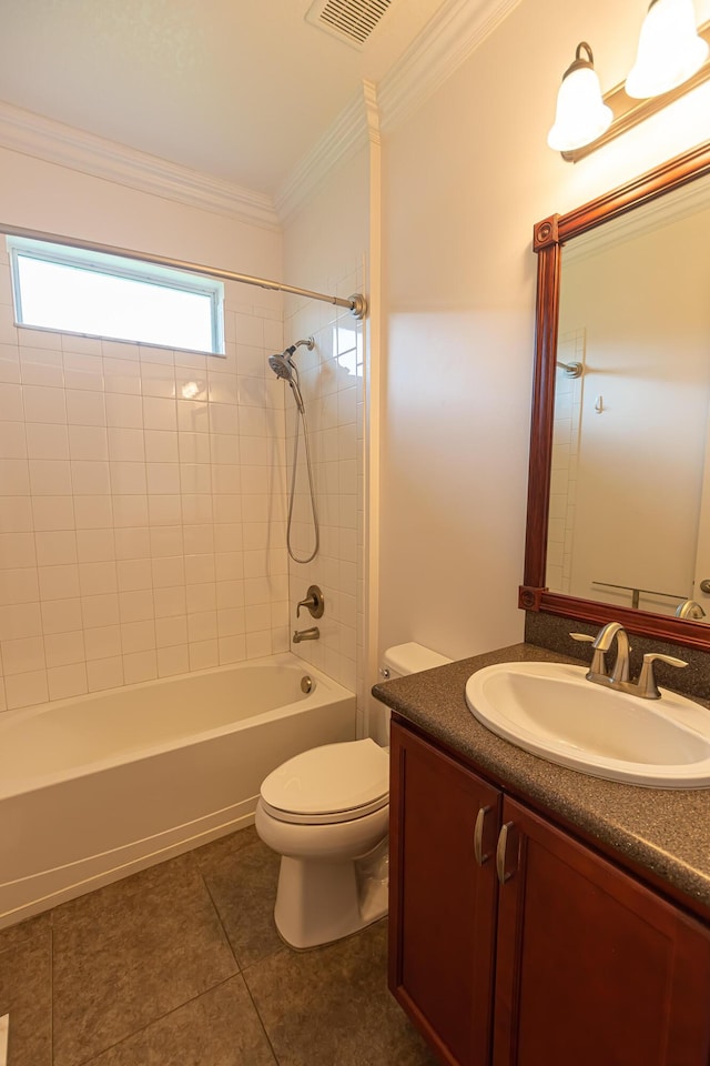 full bathroom featuring tiled shower / bath, tile patterned flooring, ornamental molding, vanity, and toilet