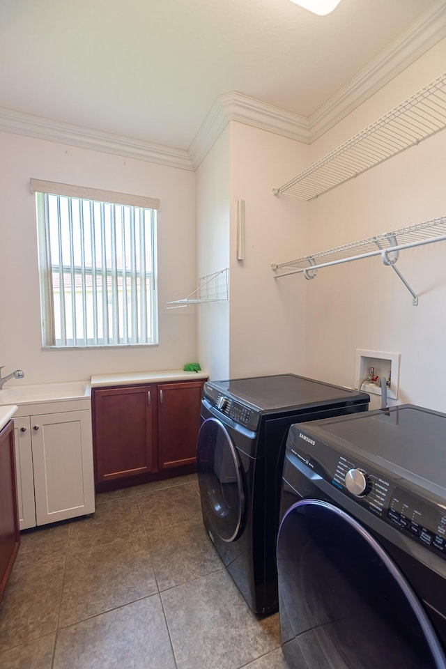 washroom with light tile patterned flooring, sink, cabinets, ornamental molding, and independent washer and dryer