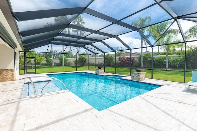 view of swimming pool with a patio, a lanai, and a yard