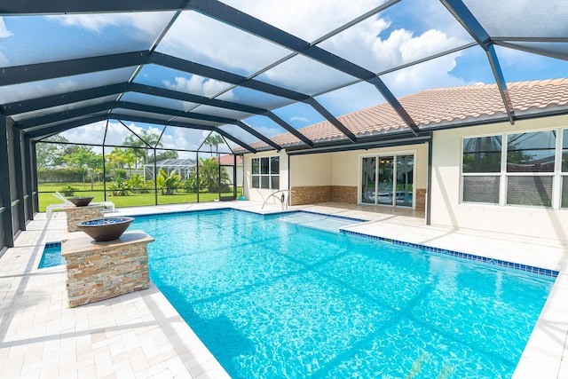 view of swimming pool with a lanai and a patio