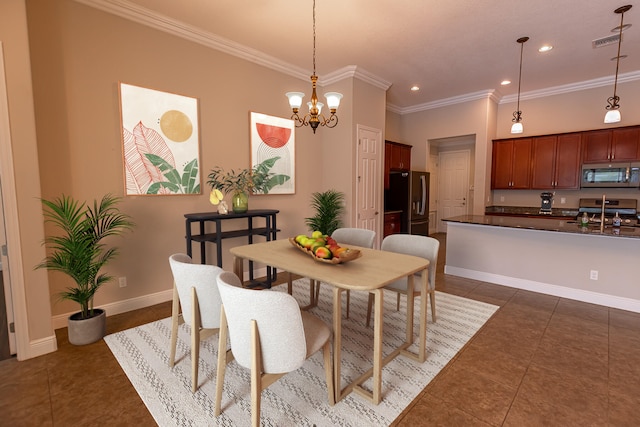 dining area with dark tile patterned floors, crown molding, and a notable chandelier