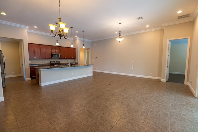 kitchen with hanging light fixtures, crown molding, a center island with sink, and appliances with stainless steel finishes