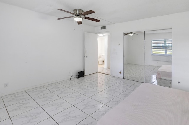 unfurnished bedroom with ceiling fan and a closet