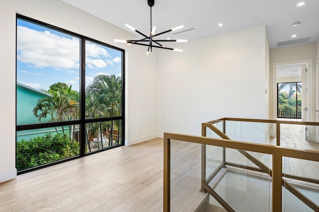 interior space featuring visible vents, baseboards, a notable chandelier, recessed lighting, and light wood-style flooring