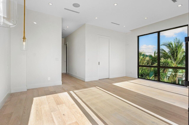 interior space with baseboards, recessed lighting, and light wood finished floors