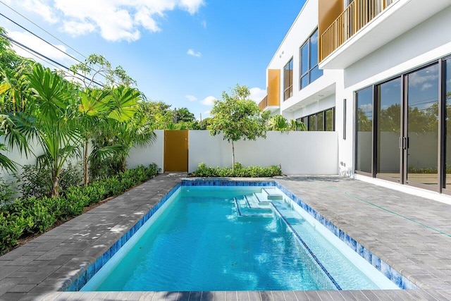 view of pool with a fenced in pool and fence