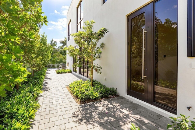 doorway to property featuring stucco siding