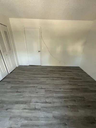 interior space featuring a textured ceiling and dark wood-type flooring