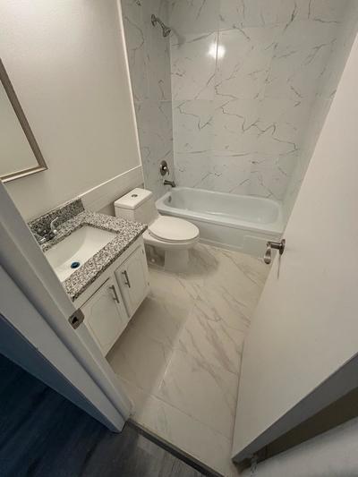 full bathroom featuring shower / tub combination, vanity, and toilet