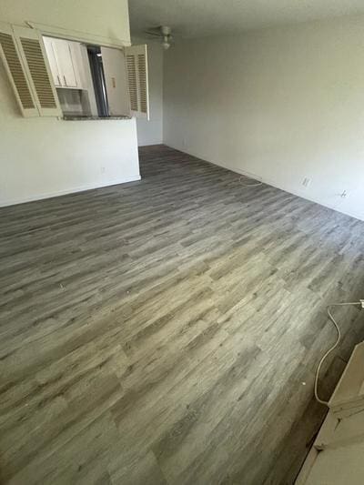 unfurnished living room featuring dark hardwood / wood-style flooring