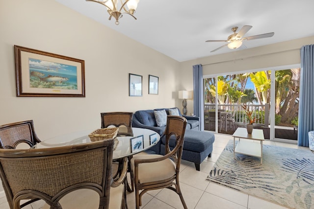 tiled living room with ceiling fan with notable chandelier