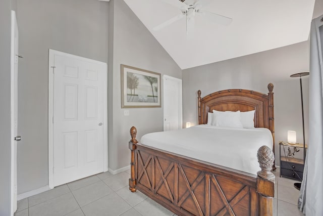 tiled bedroom with ceiling fan and vaulted ceiling