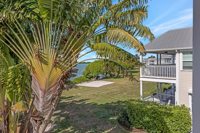 view of yard with a balcony and a water view