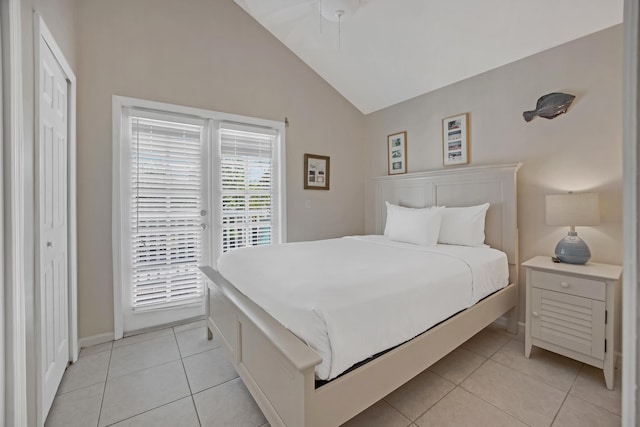 bedroom featuring access to outside, a closet, lofted ceiling, light tile patterned flooring, and ceiling fan