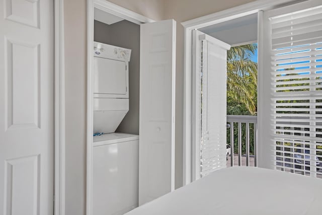 bedroom with stacked washer / drying machine