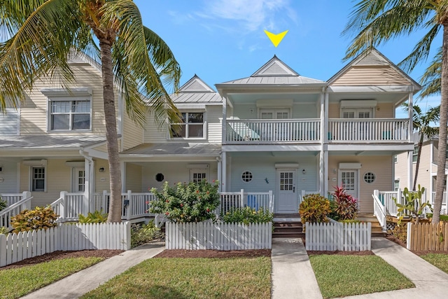 townhome / multi-family property featuring a balcony and covered porch