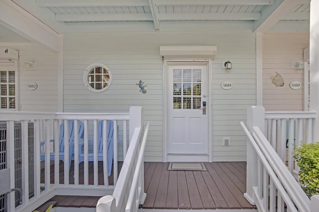 property entrance featuring a wooden deck