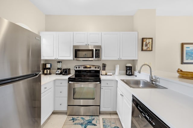 kitchen with sink, stainless steel appliances, and white cabinetry