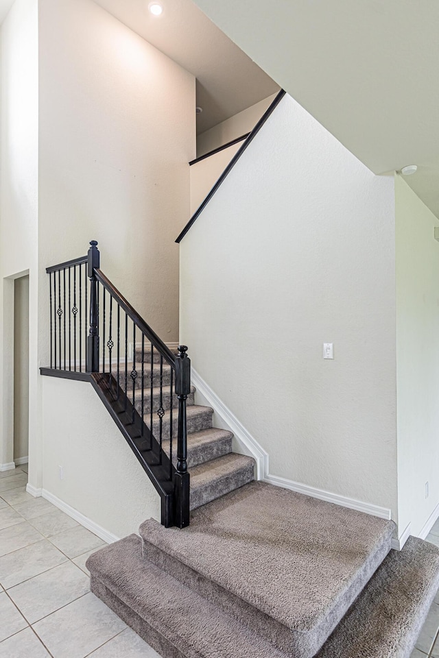 staircase with tile patterned flooring