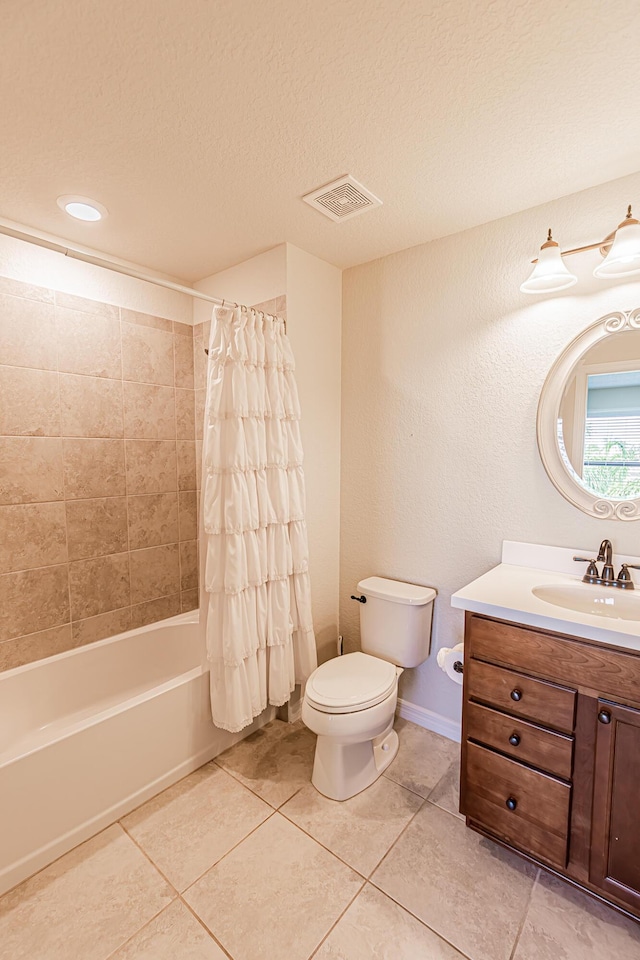 full bathroom featuring vanity, toilet, tile patterned floors, a textured ceiling, and shower / bath combo with shower curtain