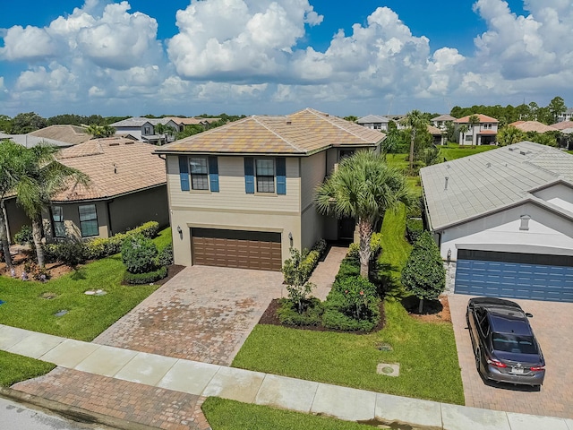 view of front of home featuring a garage and a front yard