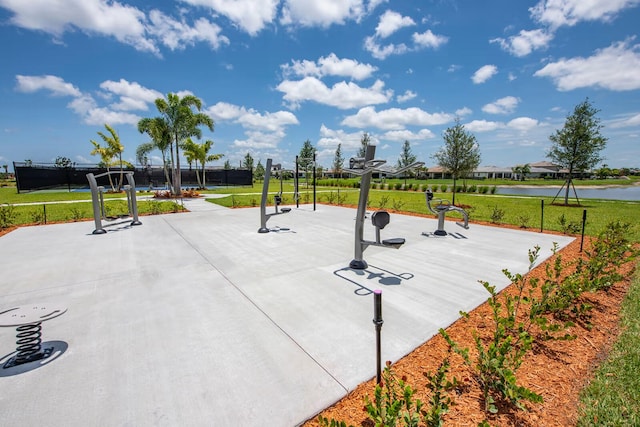 surrounding community with a water view, basketball court, and a lawn