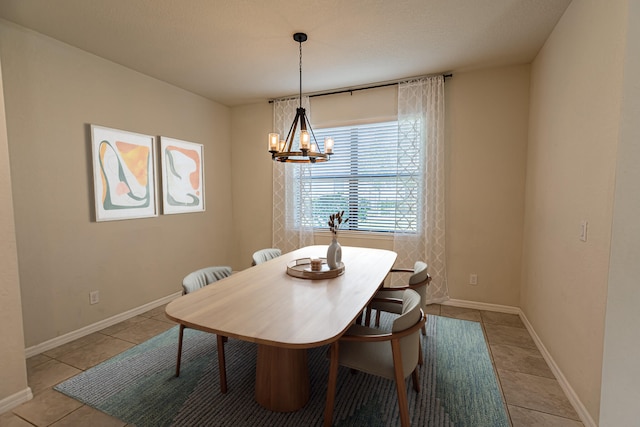 dining area with light tile patterned flooring and an inviting chandelier