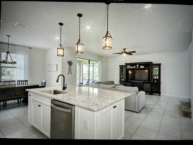 kitchen with stainless steel dishwasher, a kitchen island with sink, sink, and white cabinets