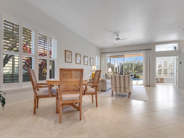 sitting room with light tile patterned floors, a textured ceiling, and ceiling fan