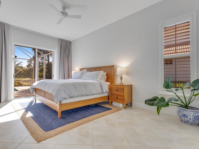 bedroom with ceiling fan, light tile patterned flooring, lofted ceiling, and access to outside