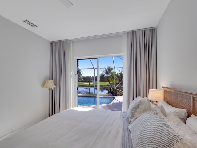 bedroom with access to exterior and a water view