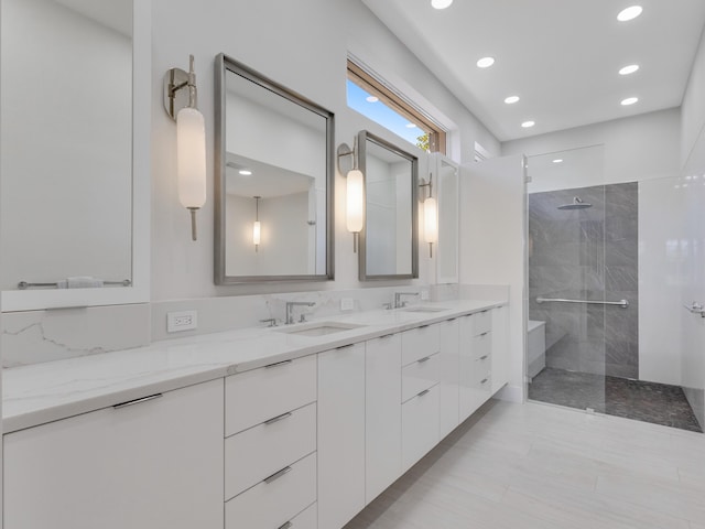 bathroom with vanity and tiled shower