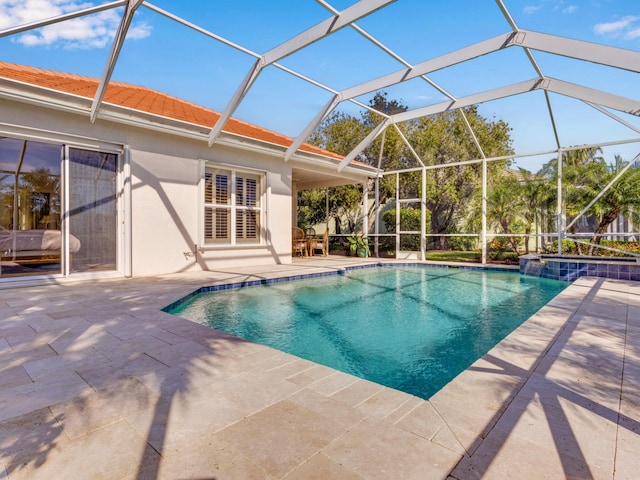 view of swimming pool featuring a lanai, a patio area, and an in ground hot tub