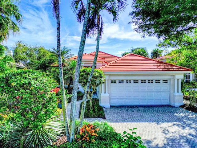 mediterranean / spanish-style home with a garage