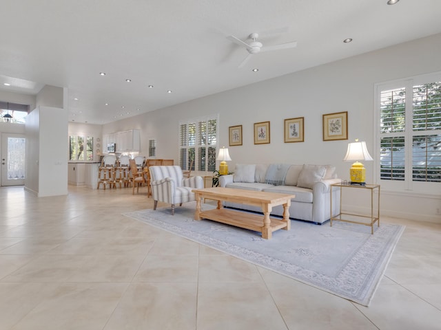 tiled living room with ceiling fan and plenty of natural light