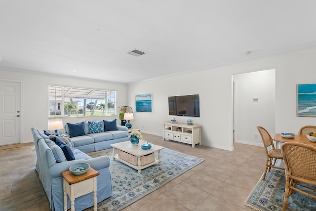 living room featuring light tile patterned floors and crown molding