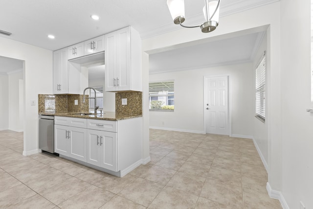 kitchen featuring dark stone countertops, dishwasher, sink, and white cabinets