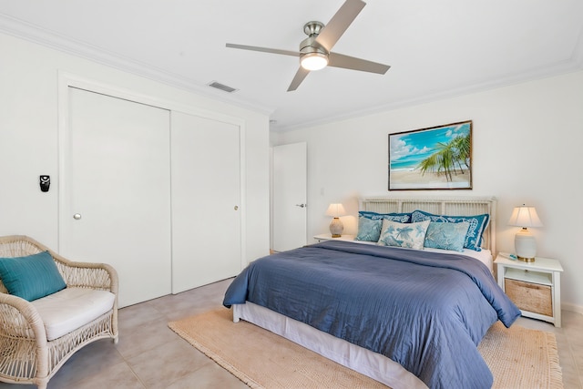 bedroom with a closet, ceiling fan, crown molding, and light tile patterned flooring