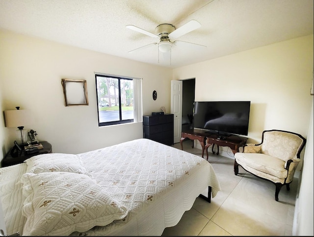 bedroom with ceiling fan and light tile patterned flooring