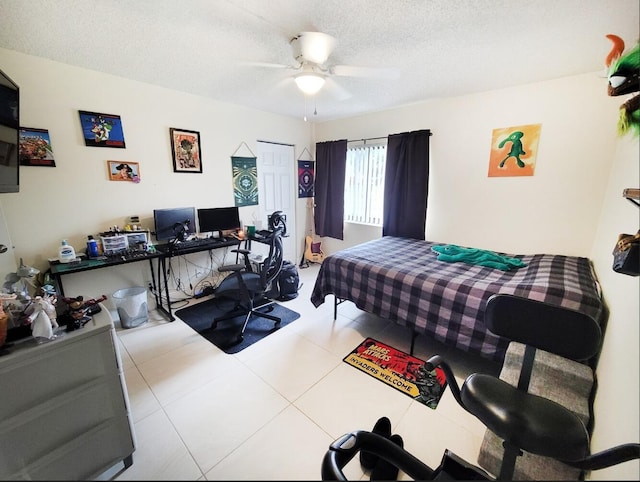 tiled bedroom with a textured ceiling, a closet, and ceiling fan